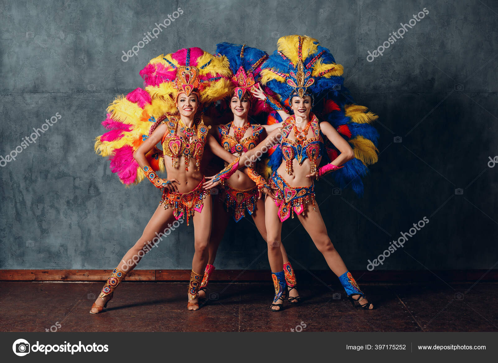 Woman in brazilian samba carnival costume with colorful feathers plumage  with mobile phone take selfie in old entrance with big window Stock Photo