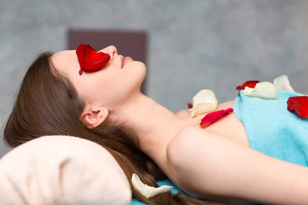 Young beautiful woman laying and relaxing in beauty spa after massage. — Stock Photo, Image