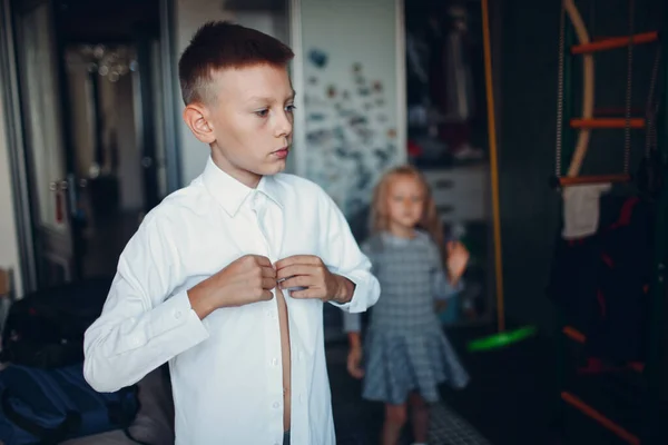 Joven y su hermana pequeña vistiendo uniforme de preparación de vuelta a la escuela. — Foto de Stock