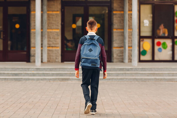 Young boy with backpack going back to school