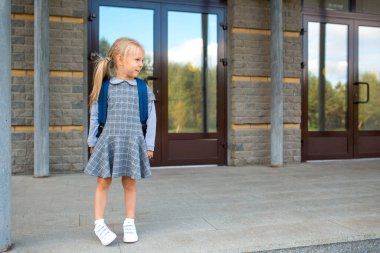 Sırt çantalı şirin kız okula geri dönüyor.