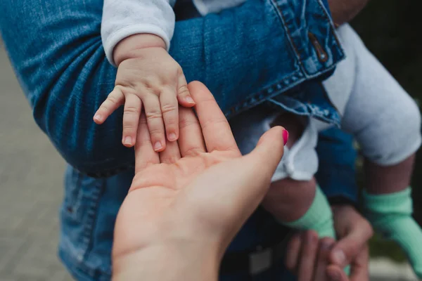 Eltern halten die Hand eines kleinen Kindes — Stockfoto