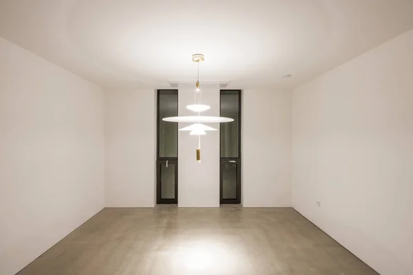 empty office with ceiling lighting in a white interior.