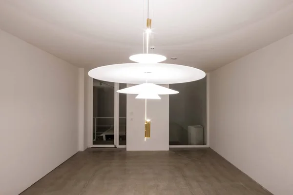 empty office with ceiling lighting in a white interior.