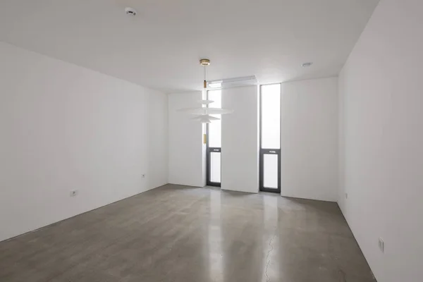 empty office with ceiling lighting in a white interior.