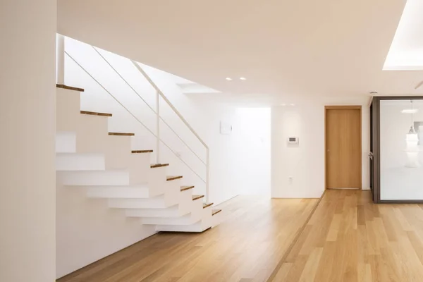 white empty living room with stair, wood floor.