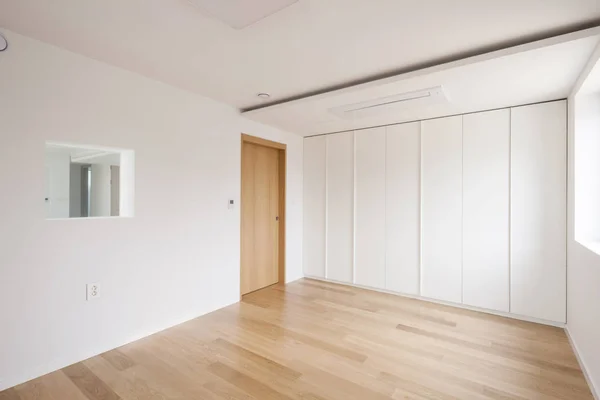 the white room with the white closet(wardrobe) at the daylight.