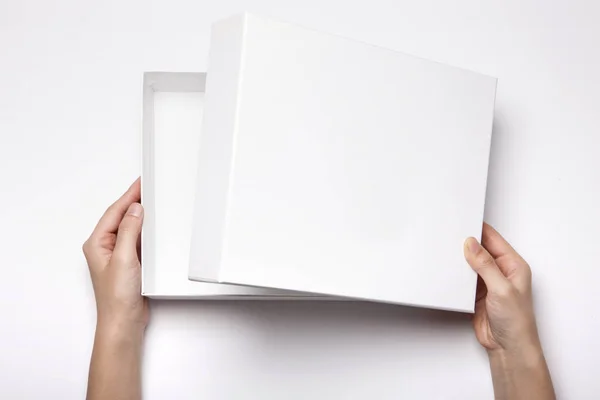 Mano Donna Tenere Una Scatola Bianca Sul Tavolo Bianco — Foto Stock