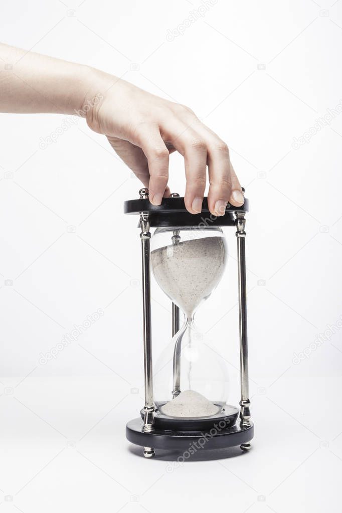 Businessman holding sand glass on palm isolated white.