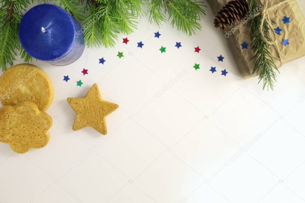 Christmas composition. Christmas frame of fir branches, cookies, gift box and candle. Christmas Wallpaper. Flat position, top view