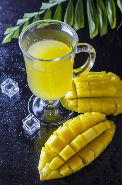 Fresh mango and mango juice in a glass