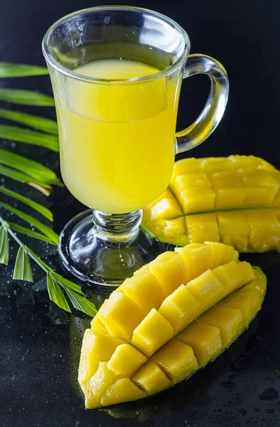 Fresh mango and mango juice in a glass