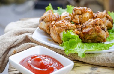 bir tabak ve soslu kızarmış tavuk kanatları