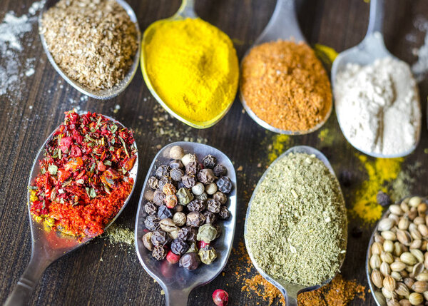 set of different spices and spices in spoons