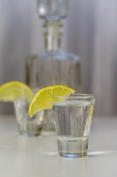 Vodka in a glass with lemon — Stock Photo, Image