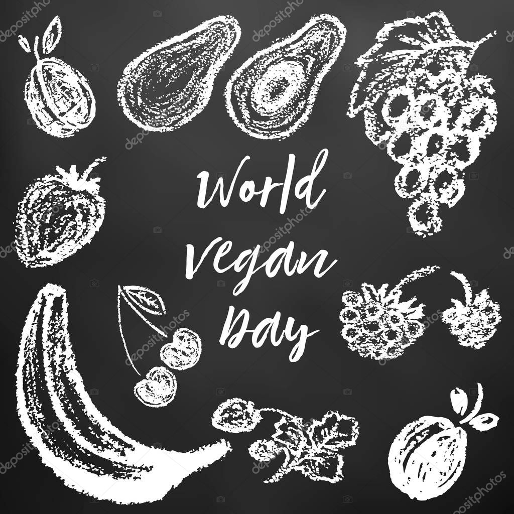 Children's drawing of white chalk on a black board. World Vegan Day. Plum, avocado, grapes, raspberries, strawberries, cherries, strawberries, banana, apricot