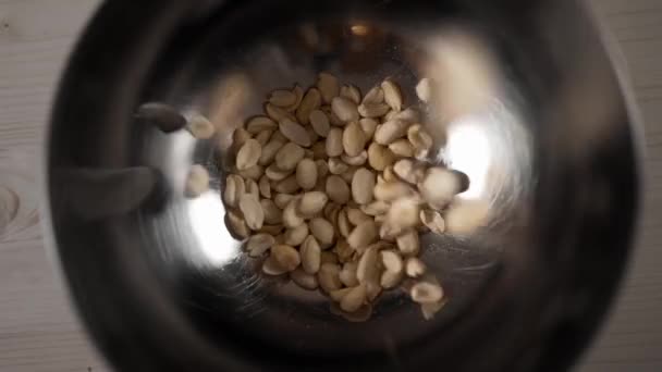 Roasted peanut falls in slow motion to the iron bowl, snacks for beer, salted nuts, fast food, 60fps 1080p slow motion — Stock Video