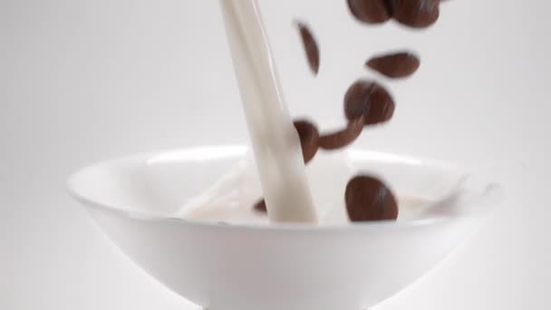 Chocolate corn flakes and milk are falling to the white bowl in slow motion, cocoa cereal breakfast falls in 240p, liquid in slow motion, rapid filming of food, Full HD 240 fps 10 bit Uncompressed — Stock Video