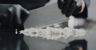 Şef çikolatalı beyaz çikolatayı büyük bıçakla eritip tatlı yapmak için, hammaddeler şeker ve çikolata yapmak için, tatlı tatlılar için, 4k 120fps Prores için küçük parçalara ayırıyor.