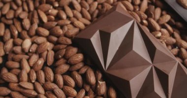 Pan shot: kavrulmuş badem üzerine çikolata, el yapımı çikolata, çikolata ve kakaonun doğal tatlısı, çikolata şekeri, 4k 120 fps Prores HQ