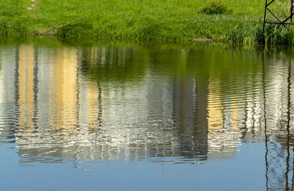 Reflection of houses in the pond of the Park of the Internationalists.