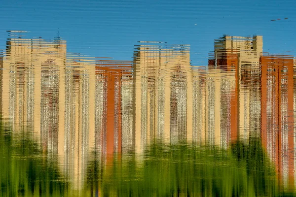 Reflection of houses in the pond of the Park of the Internationalists.