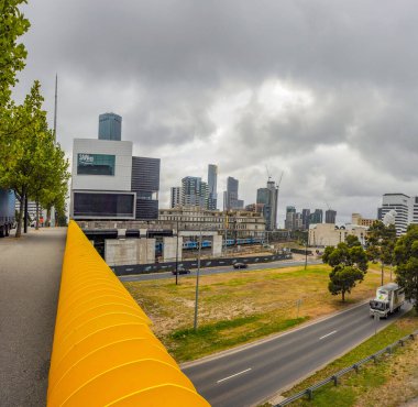 695 Collins Caddesi Rıhtımı, Melbourne, Victoria, Avustralya. 12 / 27 / 2013. Demiryolu üzerinde bir üstgeçit ve eski liman bölgesinde yeni bir seçkin şehir gelişimi.. 