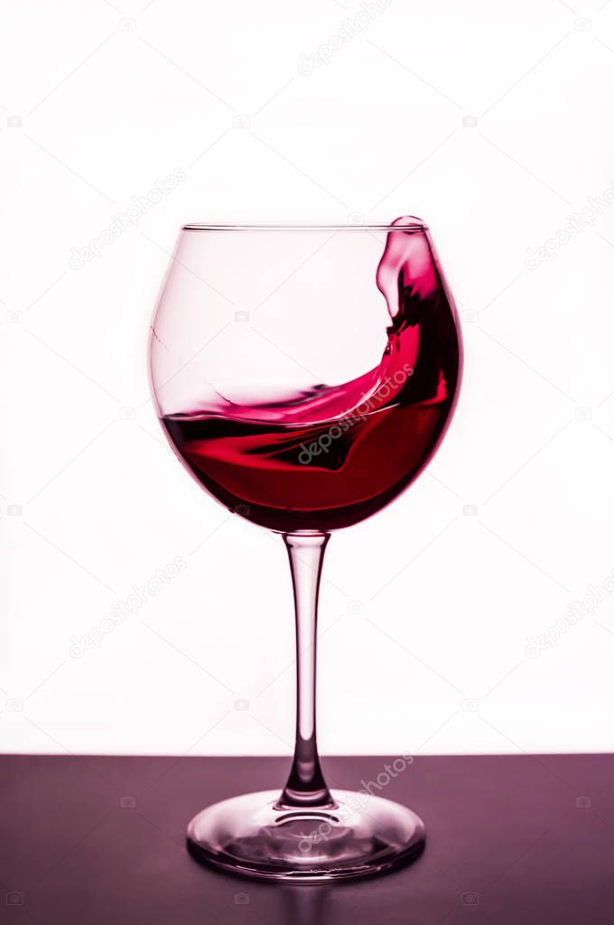 splashes of red wine in a wineglass - still life on the theme of drinks