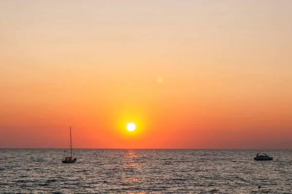 seascape and sunset, turquoise waves and orange sky