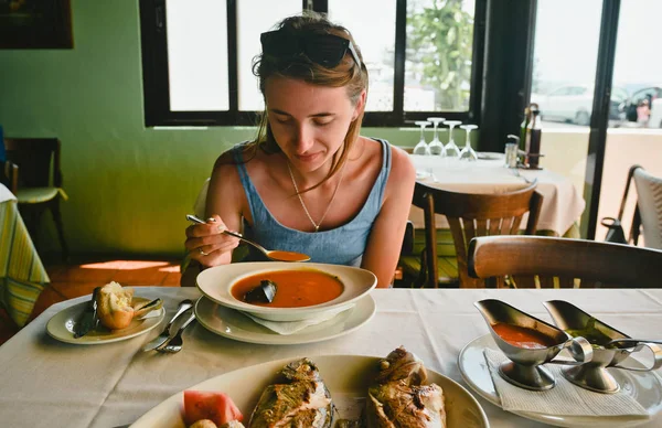 Image of young happy lady eating seafood in the restaurant. Concept of eating