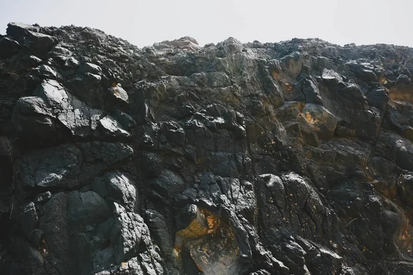 Текстура скал в горах на вулканическом острове. Фото с добавлением пленки и зернового фильтра — стоковое фото