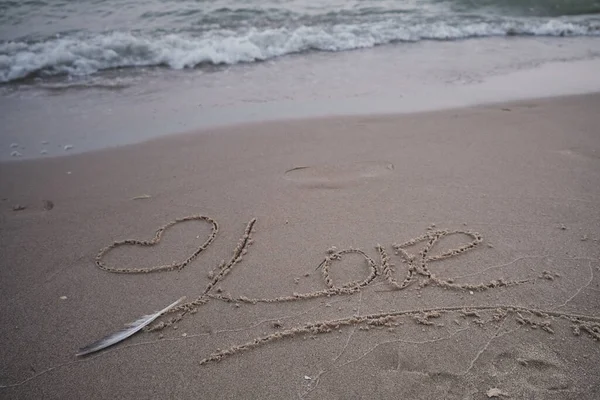 Love words in the sand of the beach. Wonderful words on beach sand. Love idea concept