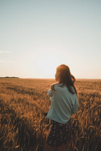 Nature landscape with dramatic clouds sunset sky. Summer background. Rear view, contour light. Travel concept
