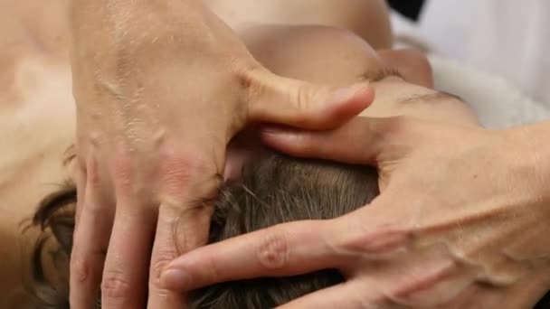 Vrouw ontvangen hoofd massage in het wellness center. vrouwelijke arts doen gezicht massage. 4k — Stockvideo