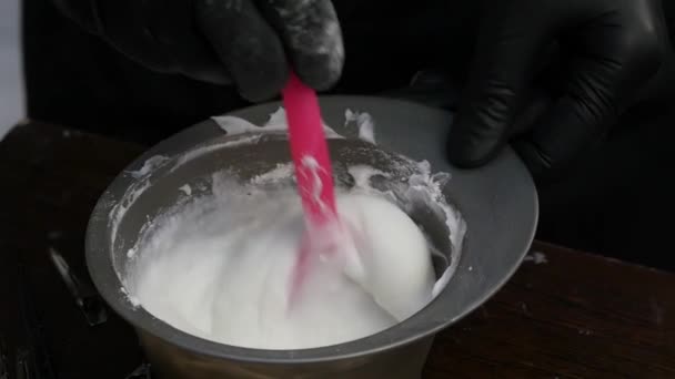 Hair dye preparation, colorist stirs with a brush, beauty salon concept. slow motion — Stock Video
