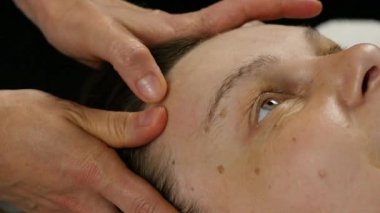 spa merkezinde masaj koltuğu alan kadın. kadın doktor yüz masaj yapıyor. ağır çekim