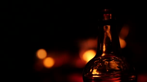 Beer bottle on a fire background in a dark. flame game on brown glass. slow motion — Stock Video