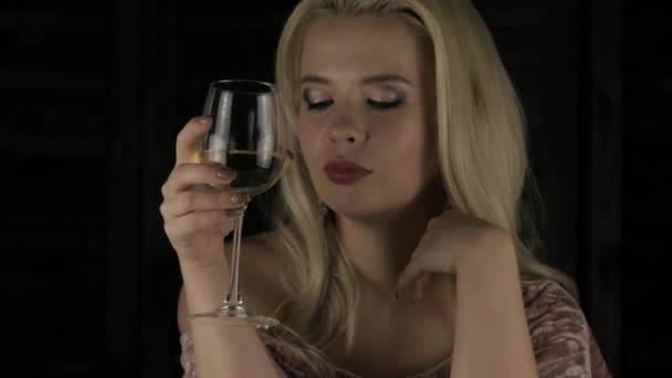 Ensam lyxiga blonda kvinna dricker champagne ensam i mörkret på en fest. 4k — Stockvideo