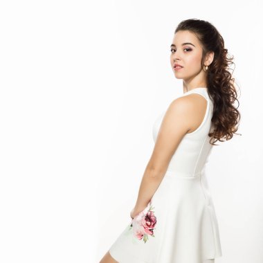 Beyaz elbiseli güzel esmer kadın omuz dışında beyaz arka plan üzerinde görünüyor. Metniniz için boş alan