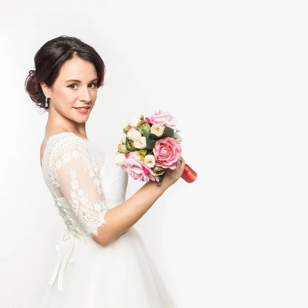 Elegant bride on a light background. Beautiful wedding bouquet in a bride hands. free space for your text — Stock Photo, Image