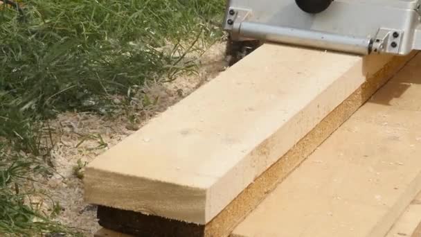 Man working on a wood planing machine. Chips fly in different side from the planer. slow motion — Stock Video