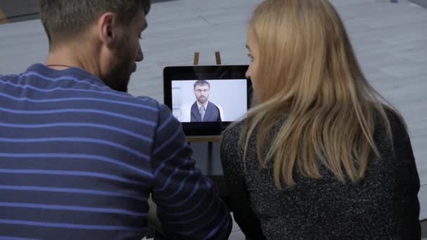 Couple having video chat with family doctor. on-line consultations — Stock Video