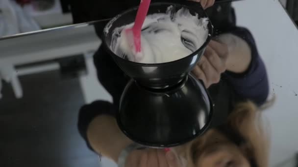 Hair dye preparation, colorist stirs with a brush, beauty salon concept. slow motion — Stock Video