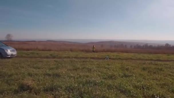 Vista aérea. mujer rubia en un camino rural de otoño cerca de coche roto. 4K — Vídeos de Stock