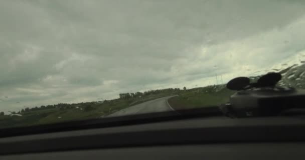 Вождение машины под дождем, капли дождя на лобовое стекло. 4K — стоковое видео