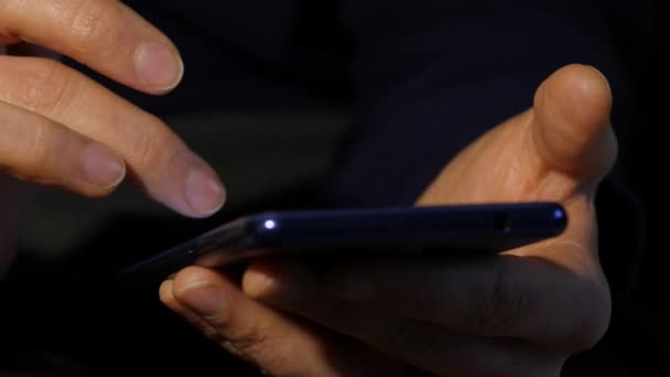 Close-up womans hands uses smartphone browsing internet for online business marking. woman uses a mobile phone. 4K — Stock Video