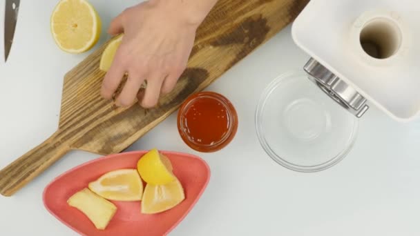 Mujer cortando un limón en la tabla de cortar — Vídeo de stock