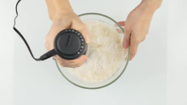 Woman making a milky fruity cocktail in a blender, smoothies preparation. 4K — Stock Video