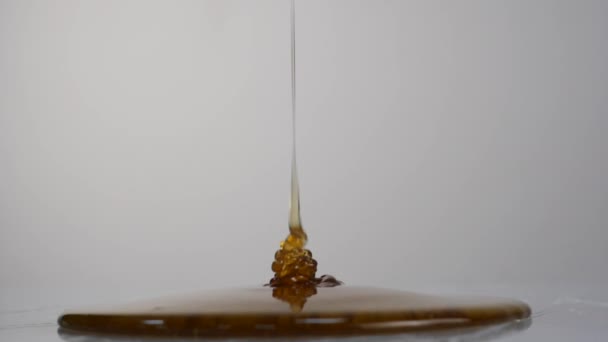 Primer plano de goteo de miel. Verter miel en la superficie. Moción lenta . — Vídeo de stock