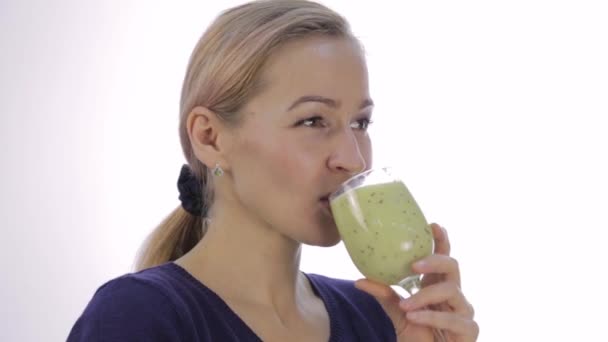 Menina loira bebe cocktail desintoxicação verde. batido vegetal para fitness e estilo de vida saudável — Vídeo de Stock